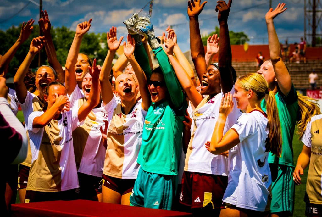 Detroit City FC hoisting the USLW League Central Conference Championship trophy.