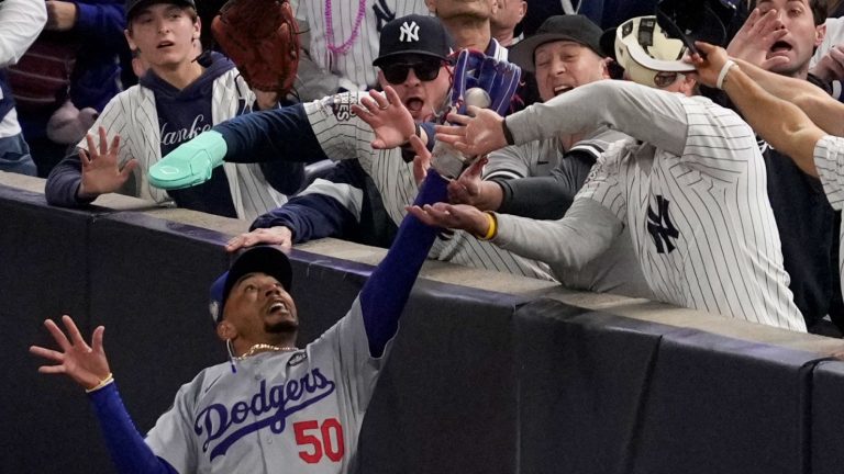 Yankees fans rip the ball from Mookie Betts' glove.