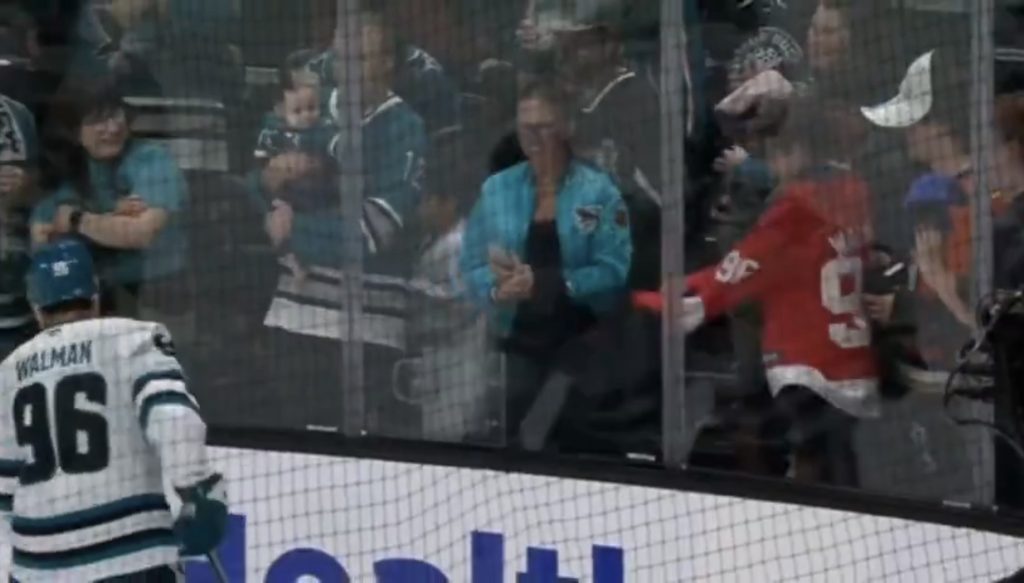 Jake Walman signs his old Red Wings jersey for a fan.