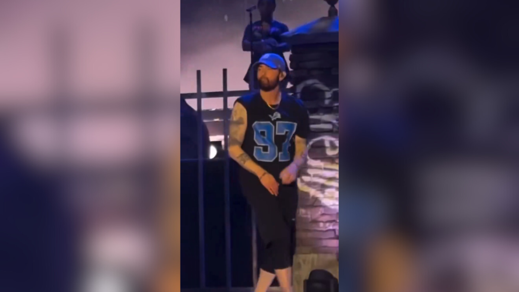 Eminem wearing a Lions Aidan Hutchinson jersey.